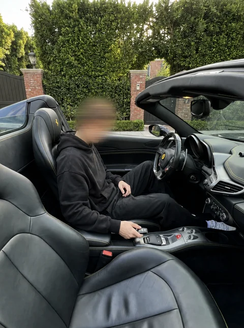 Nick sitting in an open-top car.